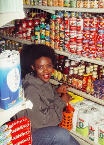 Happy Black woman shopping in grocery store