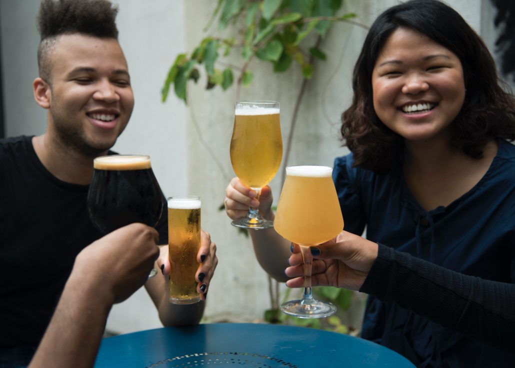 Two Multicultural consumers drinking beer