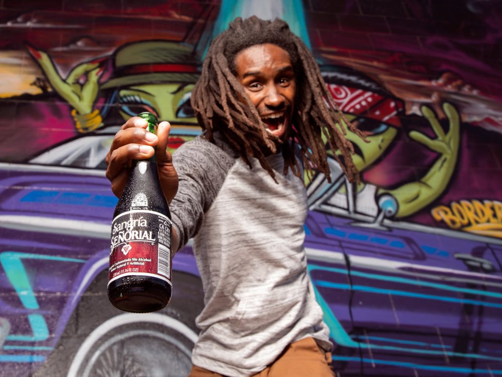 Excited Black man with alcoholic beverage
