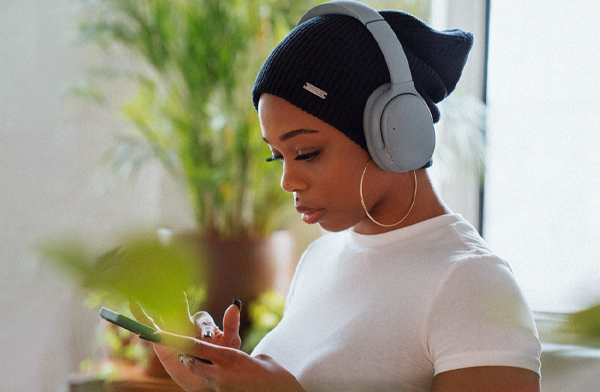 Black woman listening to music on headphones