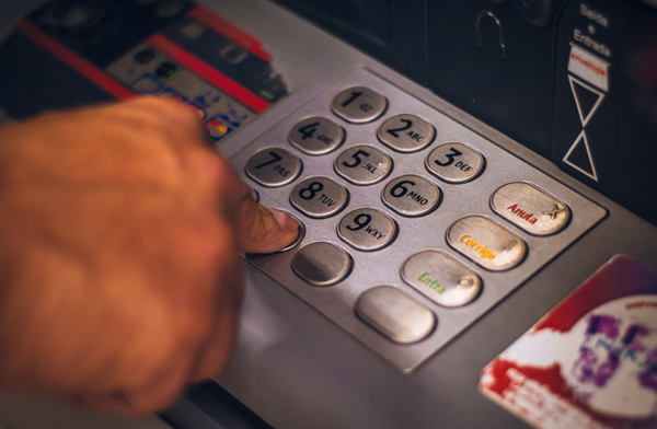 Man operating ATM machine