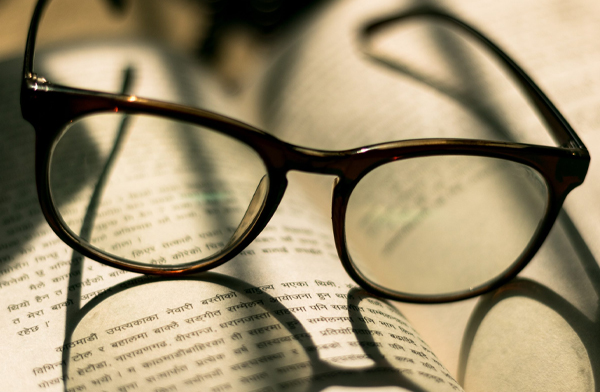 Reading glasses set on open book