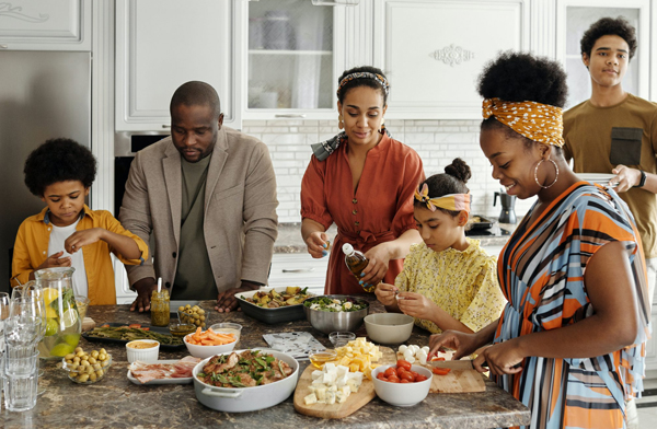 Black family with kids cooking together