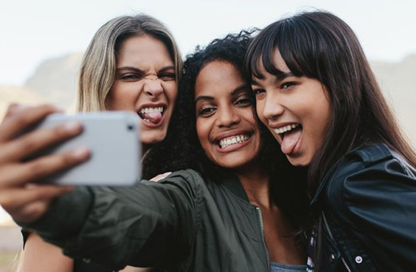Group of three multicultural women taking a selfie