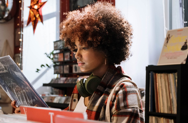 Black woman with curly hair record shopping