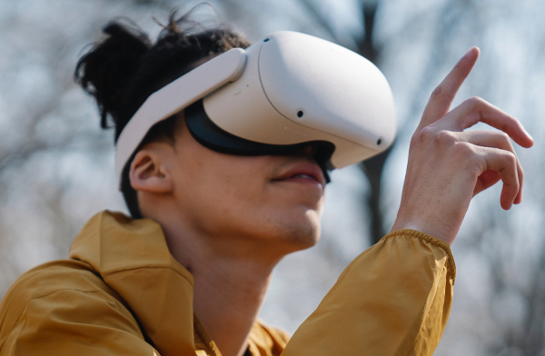 Young woman in yellow wearing a VR headset