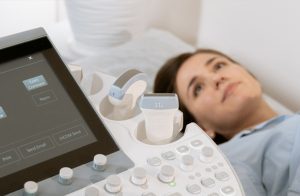 woman patient next to diagnostic machine