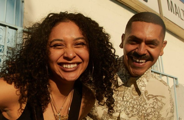 Smiling Hispanic man and woman