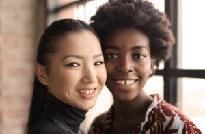 Two multicultural women smiling