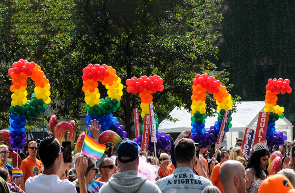 Crowd of people celebrating at LGBTQ+ pride parade