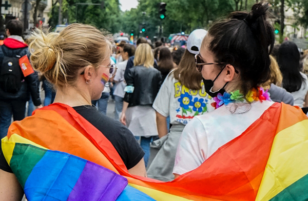 Two women marching together in Pride Parade