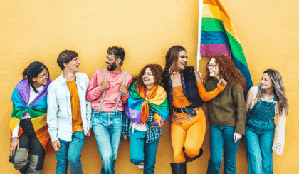 Multicultural Gen Z LGBTQ+ adults with a pride flag