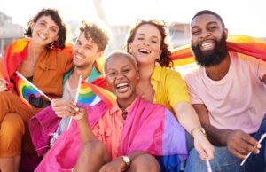 Gen Z multicultural group of friends with pride flag