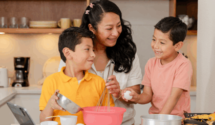 Hispanic mom cooking with her two Gen Alpha sons