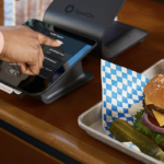 Woman ordering food at a QSR restaurant